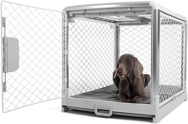 Large grey dog resting inside a Diggs Revol crate showing the diamond steel mesh and carry handle